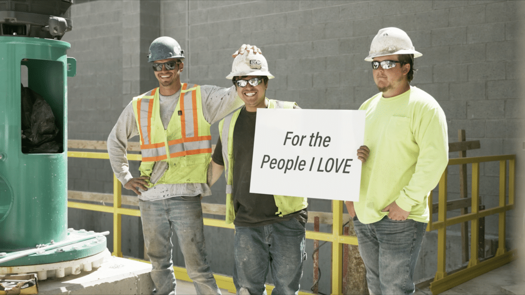 construction workers at vancon inc. are holding a sign filmed by mitch andrew visuals utah corporate videographers